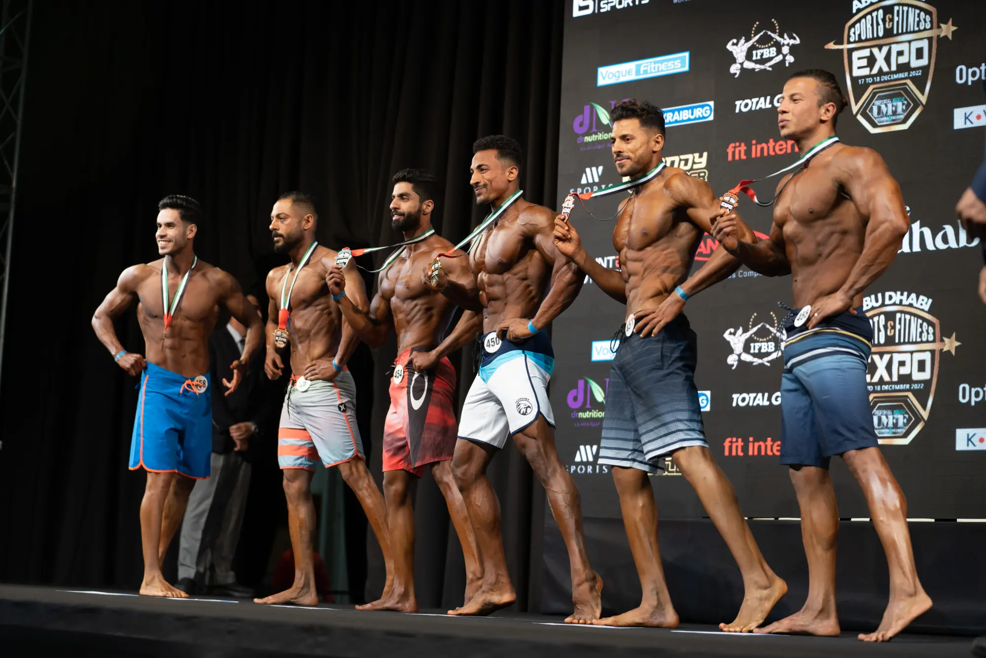 Bodybuilding line-up with medals on stage